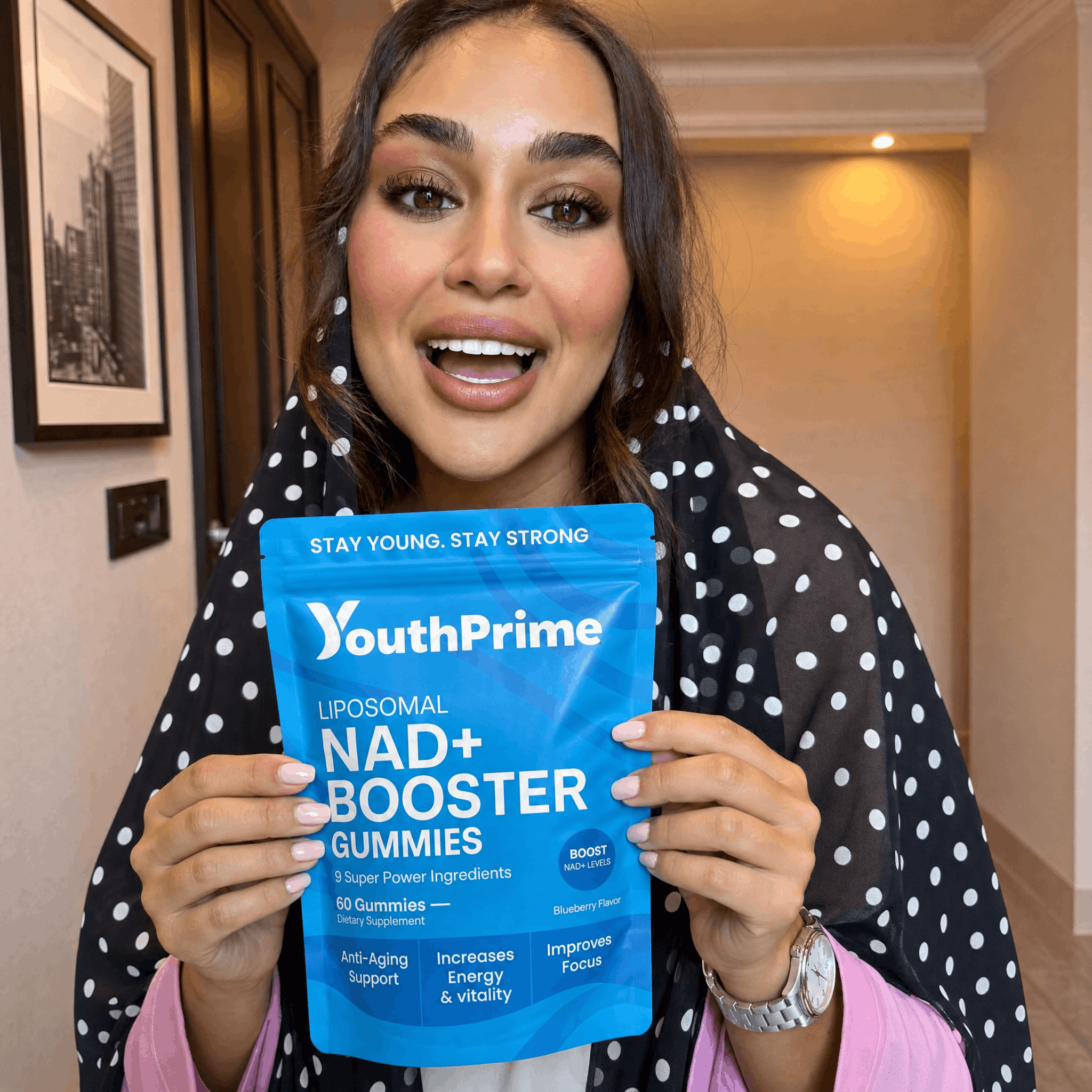 Woman holding YouthPrime NAD+ Booster Gummies